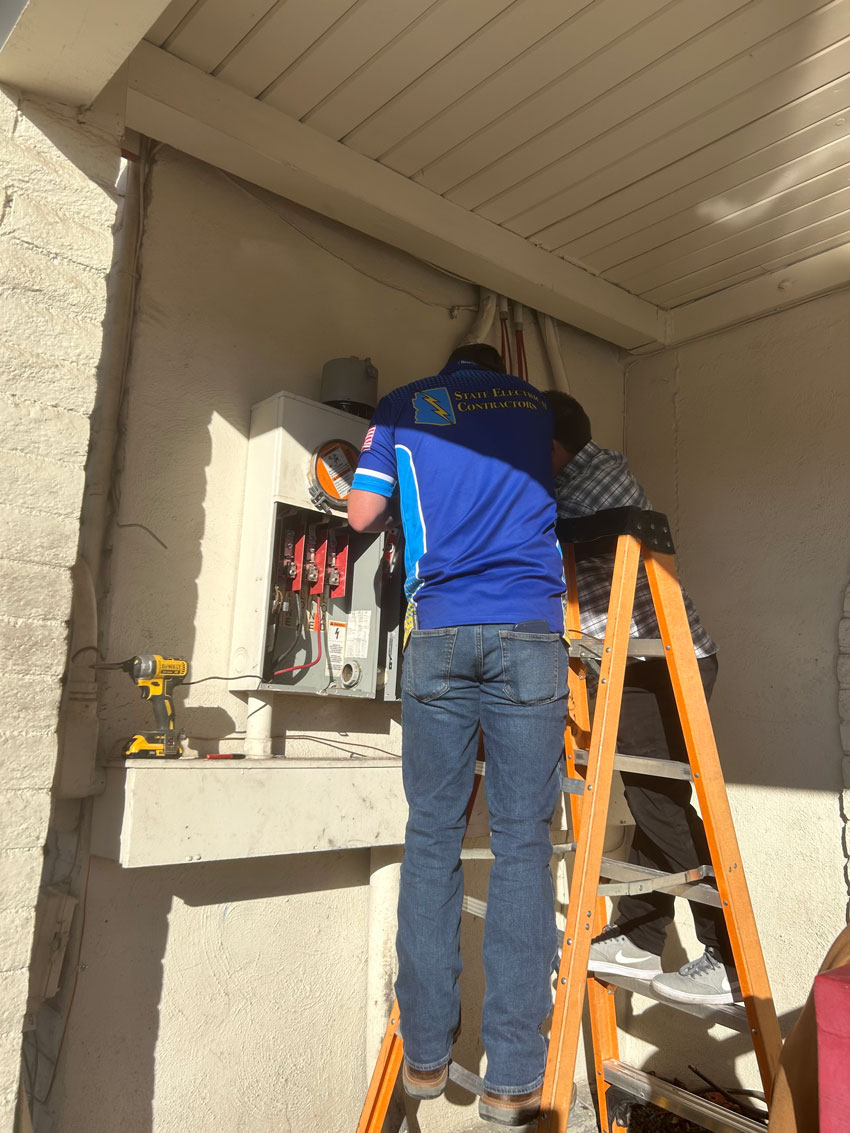 Arizona electrician working on an electrical panel in an AZ home