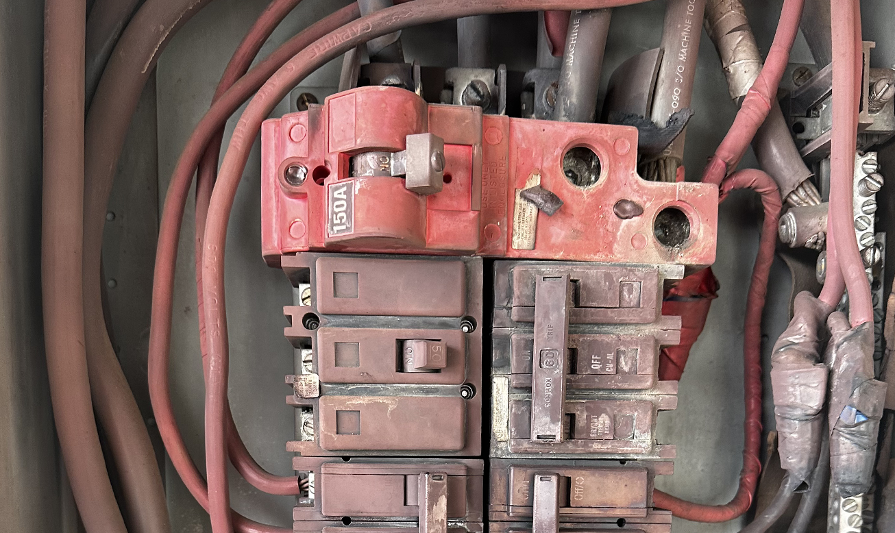Burned electrical circuit panel in Mesa Arizona showing damage from aluminum wiring, highlighting the importance of replacing outdated aluminum wiring in homes and businesses for fire safety.